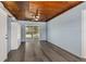 Spacious bonus room with hardwood floors, fan and access to screened-in patio at 295 W Charlotte Ave, Eustis, FL 32726
