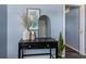 Stylish entryway featuring a black console table with decorative vase, mirror and modern decor at 295 W Charlotte Ave, Eustis, FL 32726