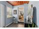 Inviting entryway with wood accents, a mirror and access to the living room at 295 W Charlotte Ave, Eustis, FL 32726