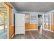 Bright kitchen with a large refrigerator, wood paneling and access to the outdoor patio at 295 W Charlotte Ave, Eustis, FL 32726