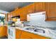 Updated kitchen featuring wood cabinets, granite countertops, and modern stainless steel appliances at 295 W Charlotte Ave, Eustis, FL 32726