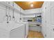 A well-lit laundry room features shelving and side-by-side washer and dryer at 295 W Charlotte Ave, Eustis, FL 32726