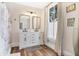 Bright bathroom with double vanity, framed mirrors, and modern fixtures in a well-lit space at 301 S Palmetto Ave, Sanford, FL 32771