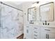 Bathroom featuring a double vanity with a shower with patterned curtain, and black fixtures at 301 S Palmetto Ave, Sanford, FL 32771