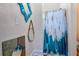 Charming bathroom with blue accents, stylish mirrors, and a shower with a unique curtain at 301 S Palmetto Ave, Sanford, FL 32771