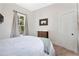 This bedroom has neutral walls, a large window and two access doors at 301 S Palmetto Ave, Sanford, FL 32771