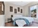 This bedroom has neutral walls, a large window and a comfortable bed at 301 S Palmetto Ave, Sanford, FL 32771