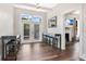 Dining room with a high table and stools near french doors leading to a patio and a view to the living room at 301 S Palmetto Ave, Sanford, FL 32771
