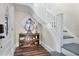 Welcoming entryway features hardwood floors, a decorative table, and stairs to the upper level at 301 S Palmetto Ave, Sanford, FL 32771