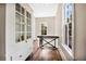 Bright hallway with hardwood floors, a built-in cabinet, and two large windows at 301 S Palmetto Ave, Sanford, FL 32771