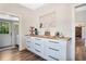 Bright kitchen featuring white cabinets with black handles and light wood countertops near the entry door at 301 S Palmetto Ave, Sanford, FL 32771