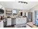 Modern kitchen with white cabinets, stainless steel appliances, and butcher block countertops at 301 S Palmetto Ave, Sanford, FL 32771