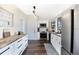 Bright kitchen with white cabinetry, butcher block counters, and stainless steel appliances at 301 S Palmetto Ave, Sanford, FL 32771