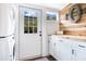 Well-lit laundry area boasts butcher block counters and wood accent wall at 301 S Palmetto Ave, Sanford, FL 32771