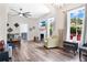 Bright living room with wood floors, fireplace, and large windows offering a view of the yard at 301 S Palmetto Ave, Sanford, FL 32771