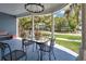 Inviting front porch with a table and chairs, perfect for relaxing and enjoying the neighborhood view at 301 S Palmetto Ave, Sanford, FL 32771