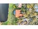 An aerial view shows a home with pool, red tile roof and lush greenery at 3156 Winding Pine Trl, Longwood, FL 32779