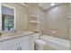 A well-lit bathroom features a sink, mirror, shelves, and a bathtub with shower at 3156 Winding Pine Trl, Longwood, FL 32779
