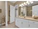 Bright bathroom featuring a large mirror, white cabinets, and a tiled floor, providing a clean and fresh feel at 3156 Winding Pine Trl, Longwood, FL 32779