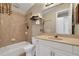 A bathroom includes a large mirror, countertop sink, and a shower with tile surround at 3156 Winding Pine Trl, Longwood, FL 32779