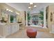 Bright bathroom with a large soaking tub, white cabinetry, and decorative plants at 3156 Winding Pine Trl, Longwood, FL 32779