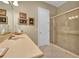 Cozy bathroom with a single sink vanity and a glass door shower, complete with neutral tones and tasteful decor at 3156 Winding Pine Trl, Longwood, FL 32779