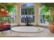 Close-up view of soaking tub, window, and lush greenery at 3156 Winding Pine Trl, Longwood, FL 32779