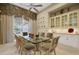 Dining room with a glass table, seating for eight, and a built-in cabinet at 3156 Winding Pine Trl, Longwood, FL 32779