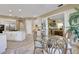 Dining room adjacent to a kitchen and living space. Dining room includes glass table and seating for six at 3156 Winding Pine Trl, Longwood, FL 32779