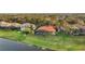 Lush backyard features an enclosed pool and an expansive lawn near a lake at 3156 Winding Pine Trl, Longwood, FL 32779