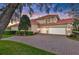 Stunning home exterior showcasing a brick driveway and a two-car garage with red roof tiles at 3156 Winding Pine Trl, Longwood, FL 32779