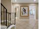 Elegant foyer with tiled flooring, staircase, and stylish decor, leading to the kitchen and other living spaces at 3156 Winding Pine Trl, Longwood, FL 32779