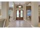 Welcoming foyer with elegant tile flooring, a decorative front door, and views into the dining and living areas at 3156 Winding Pine Trl, Longwood, FL 32779