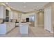 Bright kitchen with stainless steel appliances, white cabinets, central island, and tile floors at 3156 Winding Pine Trl, Longwood, FL 32779