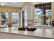 Kitchen island with cooktop and views of the water and golf course through large windows at 3156 Winding Pine Trl, Longwood, FL 32779