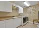 Bright laundry room with modern washer, dryer, cabinets, and sink for convenience at 3156 Winding Pine Trl, Longwood, FL 32779