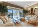 Elegant living room with neutral tones, plush seating, and sliding glass doors to a screened pool area at 3156 Winding Pine Trl, Longwood, FL 32779