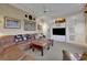Relaxing living room with a large, comfortable leather couch, TV, and built-in cabinets at 3156 Winding Pine Trl, Longwood, FL 32779