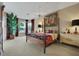 Luxurious main bedroom boasts a four-poster bed, scenic views, and plenty of natural light at 3156 Winding Pine Trl, Longwood, FL 32779