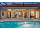 Poolside view of a home featuring an expansive patio with views from inside to the outside overlooking a sparkling pool at 3156 Winding Pine Trl, Longwood, FL 32779