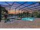 Relaxing screened pool and patio area with ample seating, perfect for entertaining with a serene lake view at 3156 Winding Pine Trl, Longwood, FL 32779