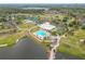 Aerial view of a community clubhouse, pool, lake and golf course at 3408 Idlegrove Ct, Orlando, FL 32822