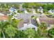 Aerial view of home with dark roof and solar panels surrounded by lush trees in a neighborhood at 3408 Idlegrove Ct, Orlando, FL 32822