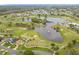 A scenic aerial view highlights a golf course community with lush greenery, ponds, and residential homes at 3408 Idlegrove Ct, Orlando, FL 32822