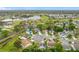 Aerial view of a neighborhood surrounding a golf course with lakes and lush greenery at 3408 Idlegrove Ct, Orlando, FL 32822
