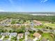 An aerial view of a residential community, lush landscaping, and a nearby lake at 3408 Idlegrove Ct, Orlando, FL 32822