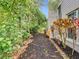 Backyard mulch bed running along the house, bordered by a brick edge at 3408 Idlegrove Ct, Orlando, FL 32822