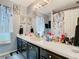 Bathroom with stylish vanity, framed mirror, modern lights and attractive, decorative wall art at 3408 Idlegrove Ct, Orlando, FL 32822