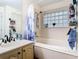 Bathroom featuring a bathtub and shower combo with a glass block window at 3408 Idlegrove Ct, Orlando, FL 32822