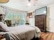 Bright bedroom featuring a large window, ceiling fan, and dark wood floors at 3408 Idlegrove Ct, Orlando, FL 32822